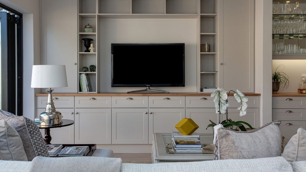Flat screen television mounted in a living room, illustrating how to move a TV Licence to a new address