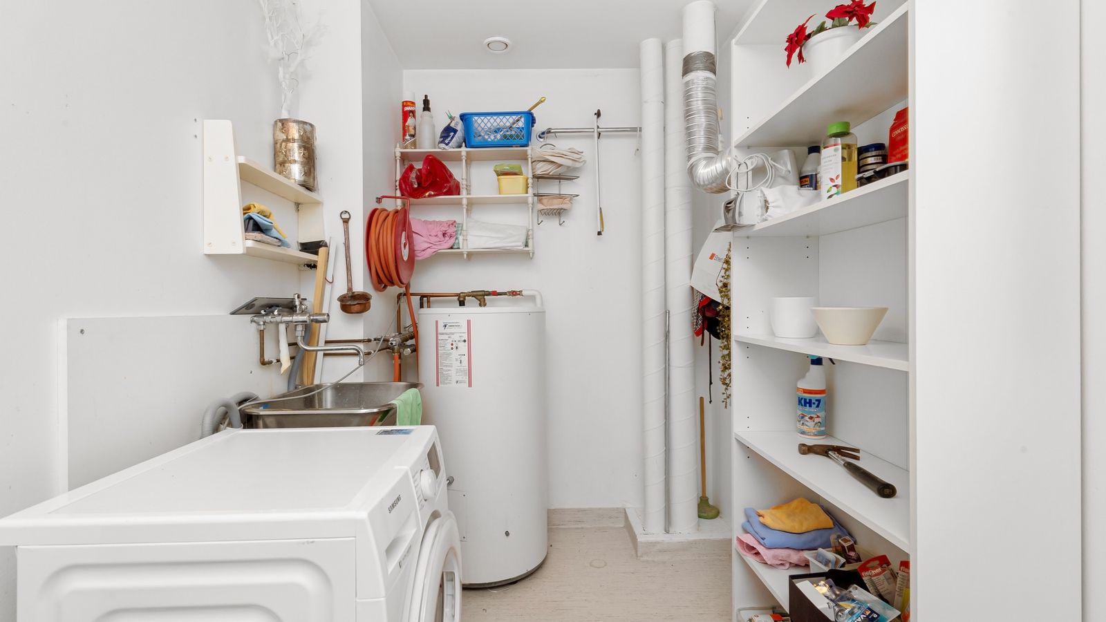 Home utility room with appliances and shelving