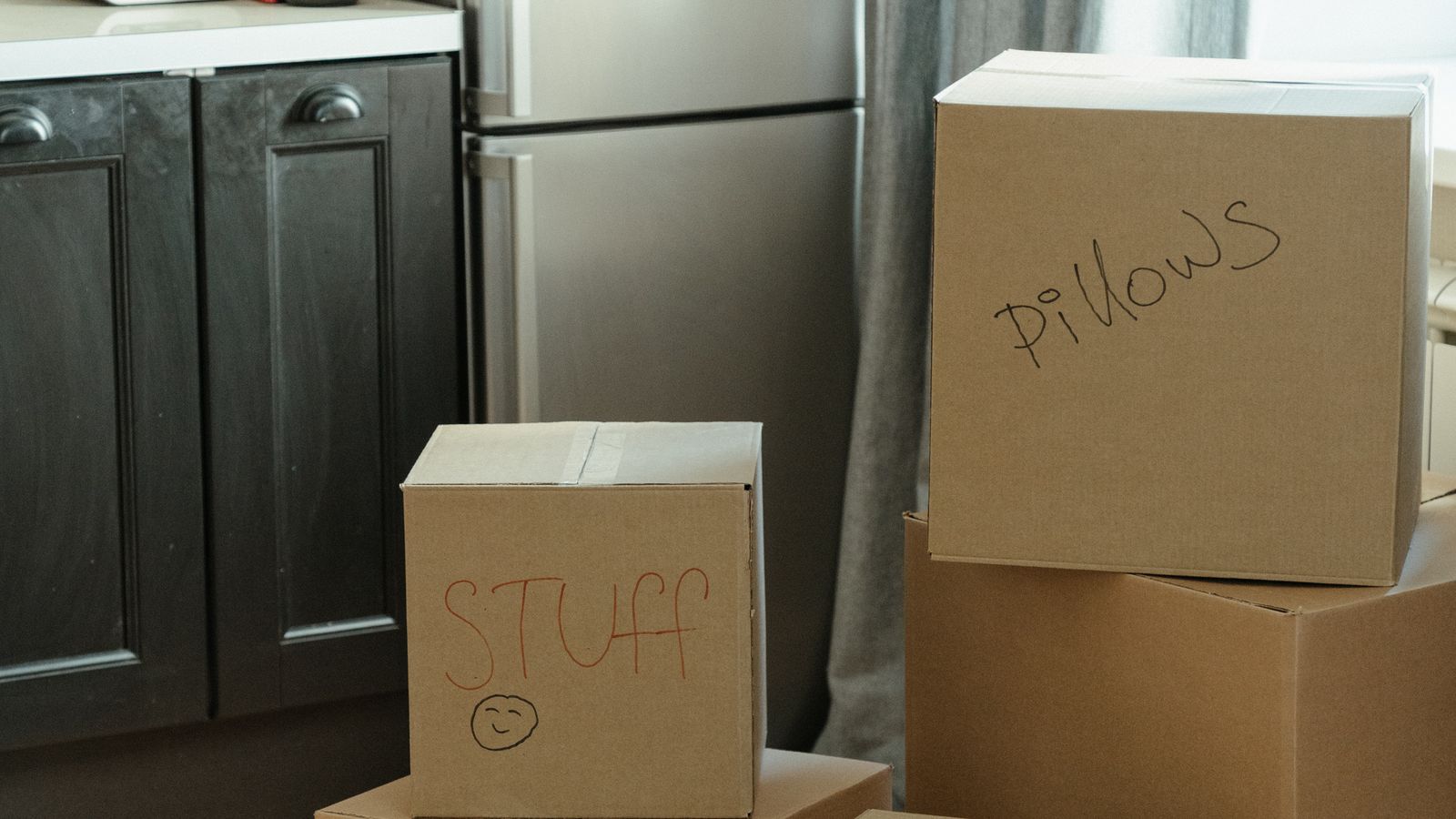 Labelled cardboard boxes in a kitchen