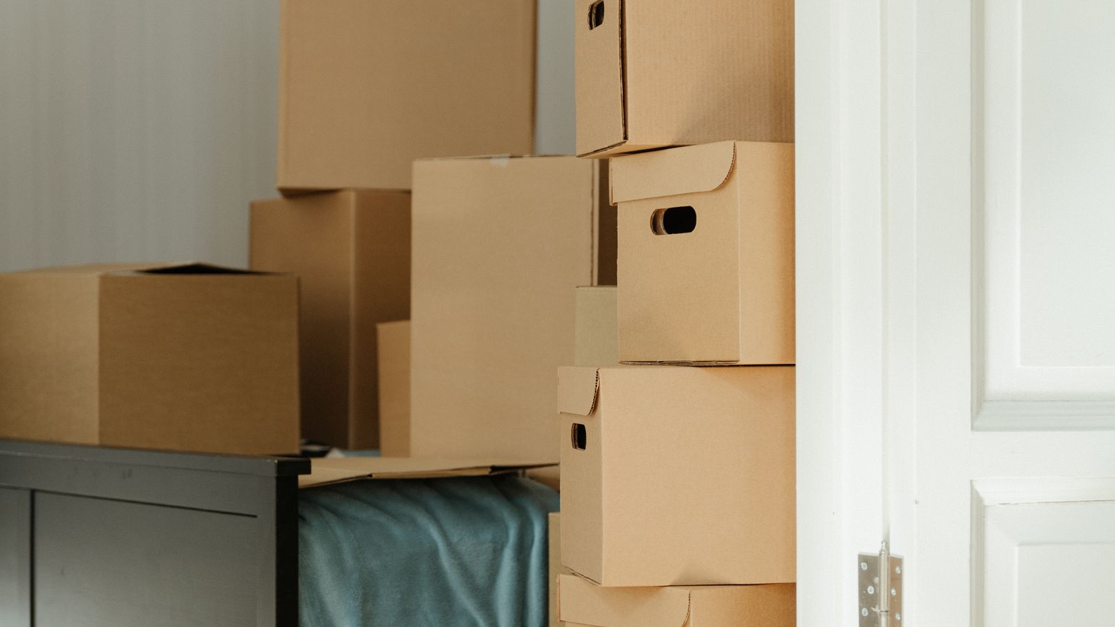 Cardboard boxes stacked in a bedroom