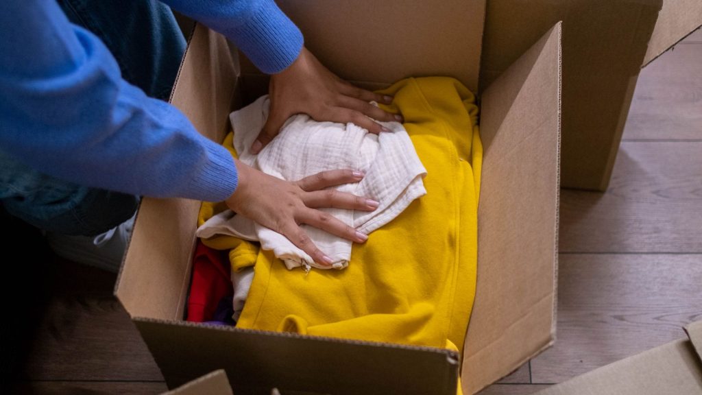 Household items being sorted into cardboard boxes before a move