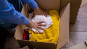 Household items being sorted into cardboard boxes before a move