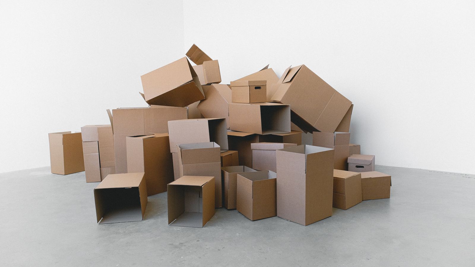 Plain cardboard moving boxes stacked on a floor