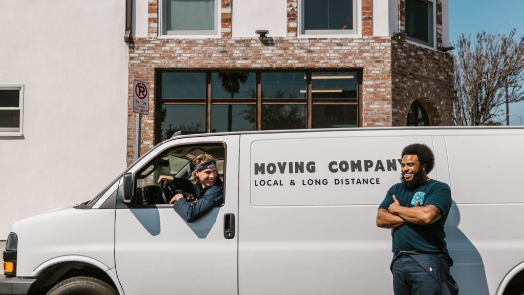 Removals team with a van parked outside a building