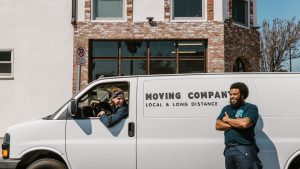 Removals team with a van parked outside a building
