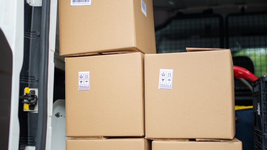 Cardboard boxes stacked inside an open van